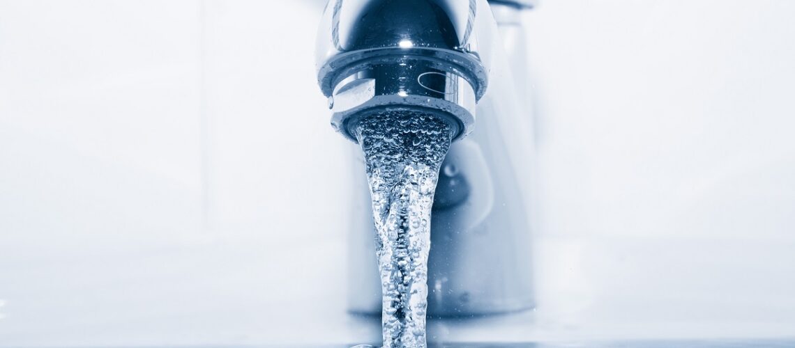 faucet-with-flowing-water-closeup